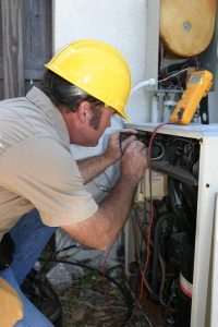 male technician doing service on an hvac system