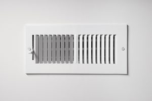 heating-cooling-vent-register-on-the-wall-of-a-home