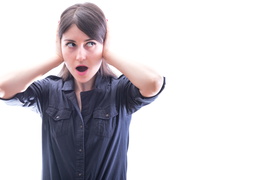 woman covering her ears, on white background