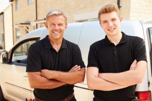 two-hvac-techs-standing-with-arms-crossed