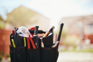 tool-bag-with-house-in-the-background