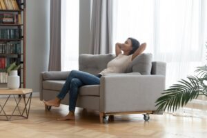 woman-leans-back-on-sofa-comfortable