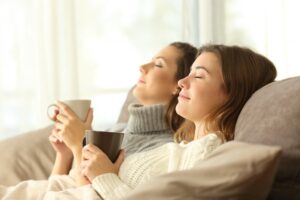 roommates-sitting-back-on-couch-looking-comfortable