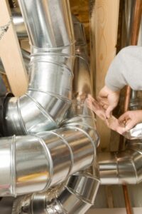 technician-repairing-duct