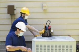 technicians-repairing-AC-unit