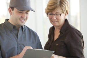 technician-going-over-paperwork-with-a-homeowner