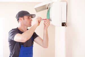 HVAC-technician-servicing-a-ductless-air-handler