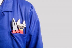 repair-tools-in-the-front-pocket-of-a-blue-work-shirt