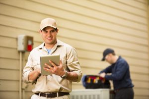 HVAC-technicians-at-an-outdoor-AC-unit